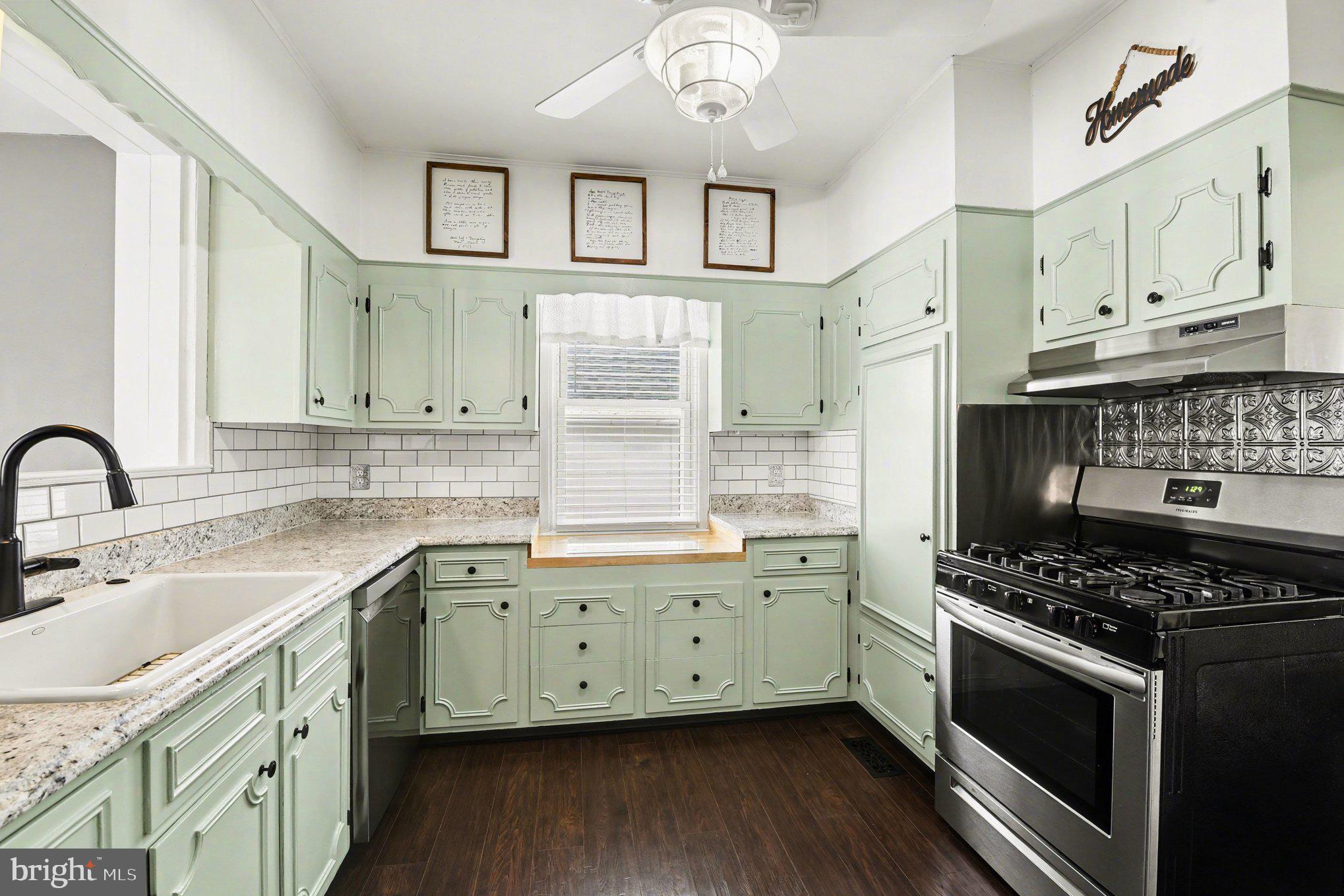 6807 North Point Road Sparrows Point, MD 21219 - Photo 8 of 28 a kitchen with stainless steel appliances a sink stove and cabinets