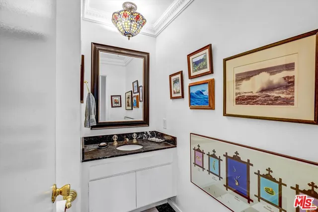 a view of a hallway with painting on the wall