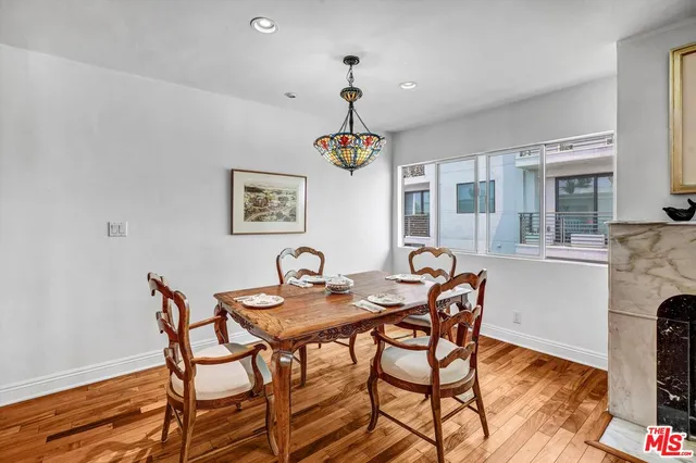 a dining room with furniture a chandelier and wooden floor