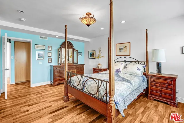 a bed room with a bed and dresser