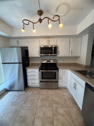 a kitchen with a cabinets and steel appliances