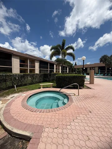a view of a patio with a table and chairs