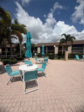 a patio with table and chairs