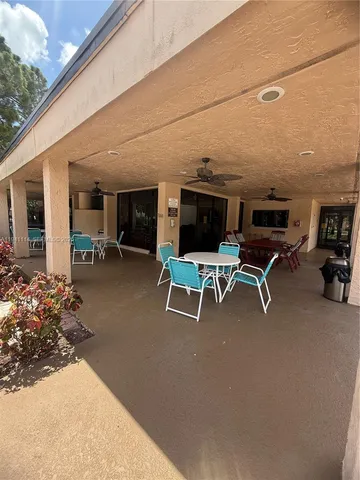 a front view of a house with a large garden and patio