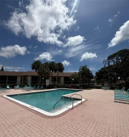 a kitchen with granite countertop a stove and a wooden cabinets