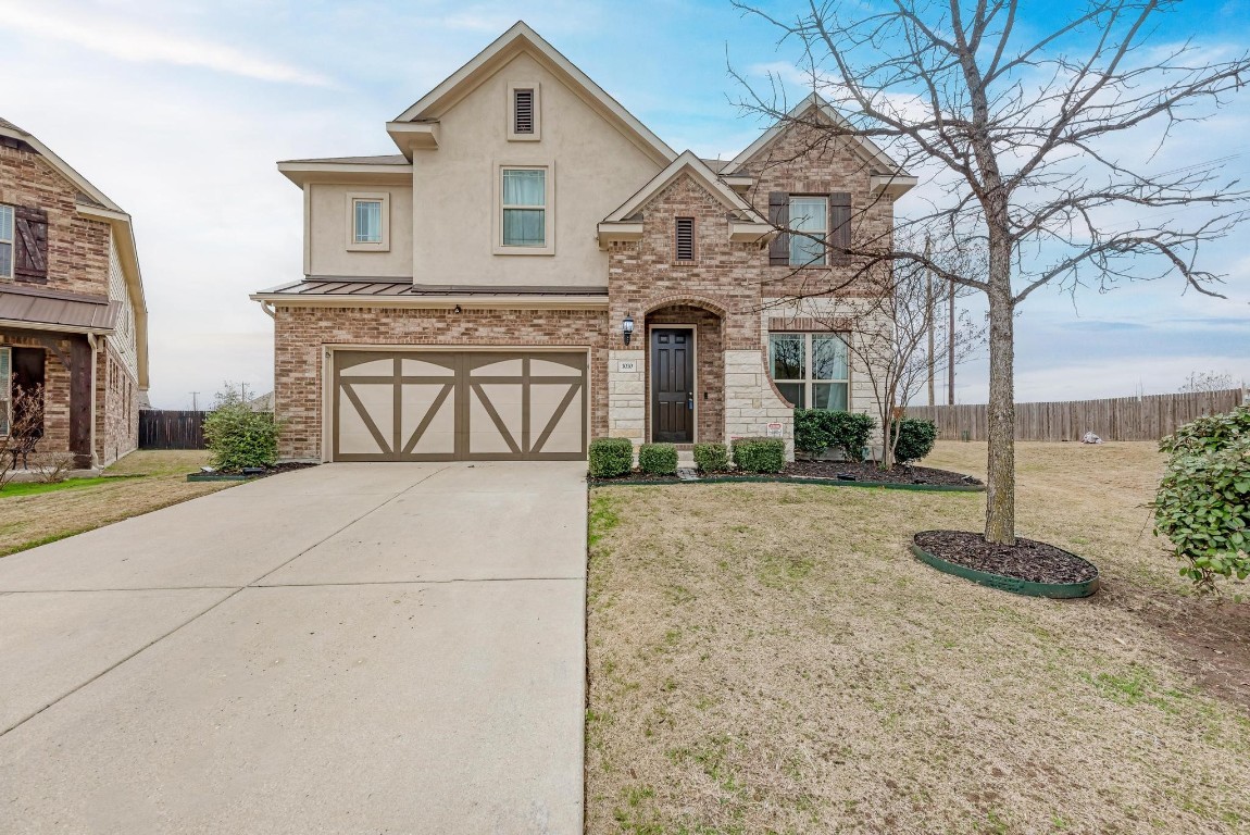 1010 Farm Creek Cove Hutto, TX 78634 - Photo 1 of 1 a front view of a house with a yard