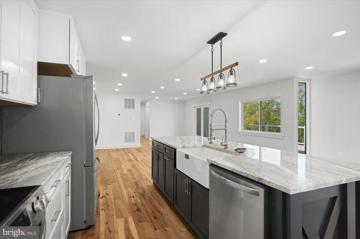 4117 Crow Rock Road Myersville, MD 21773 - Photo 12 of 97 a large kitchen with kitchen island a large island in it