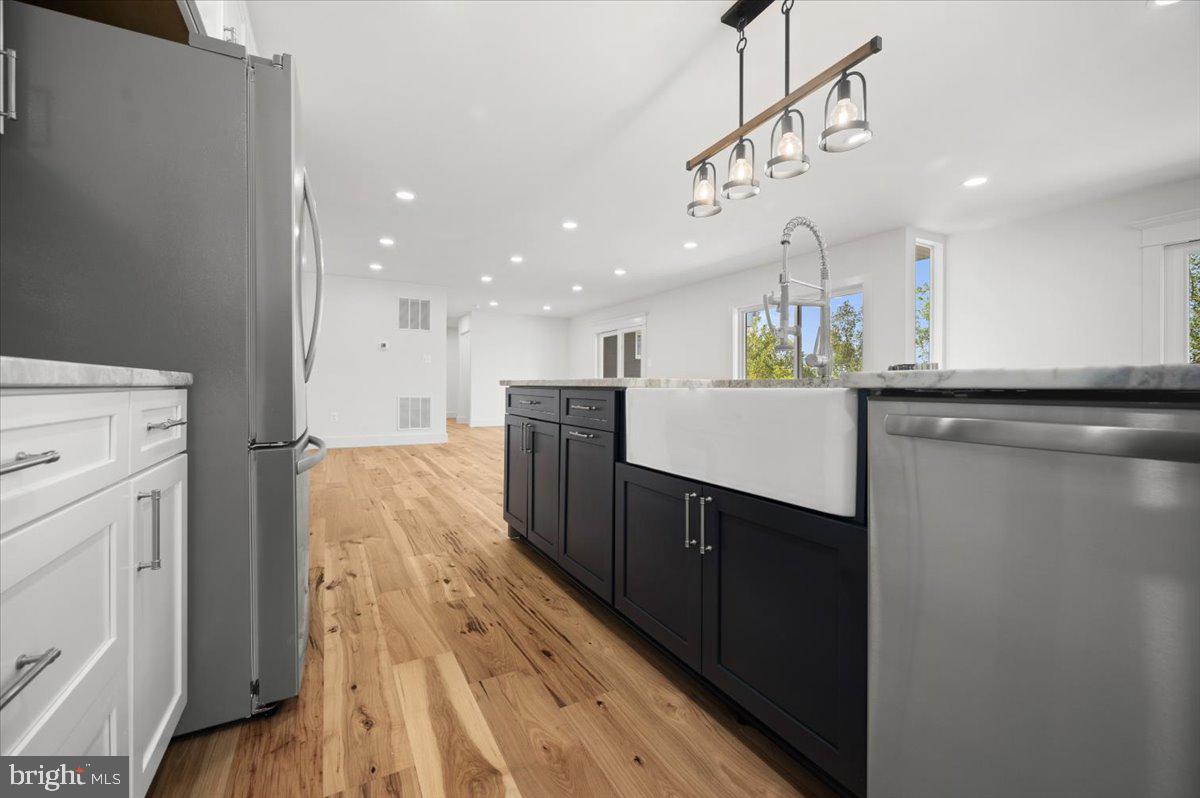 4117 Crow Rock Road Myersville, MD 21773 - Photo 13 of 97 a kitchen with a sink stainless steel appliances a counter top space and cabinets