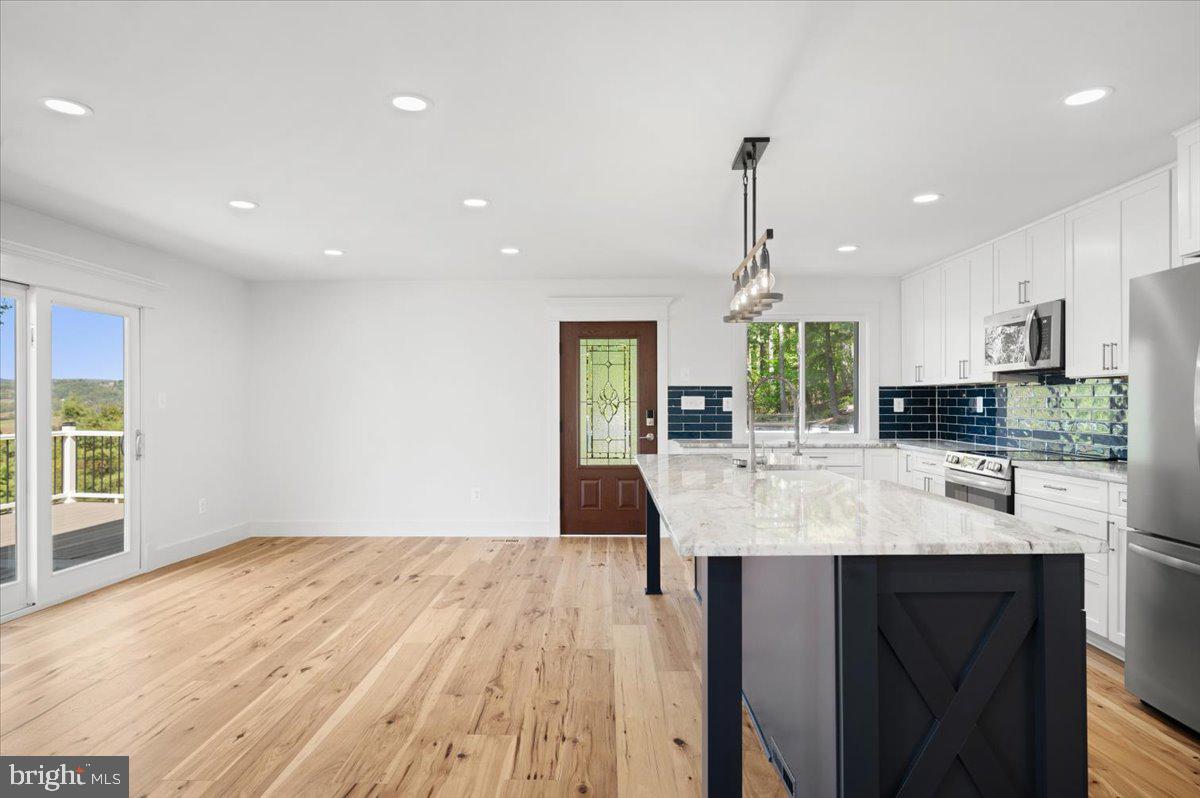 4117 Crow Rock Road Myersville, MD 21773 - Photo 14 of 97 a kitchen with kitchen island granite countertop a stove and a wooden floors