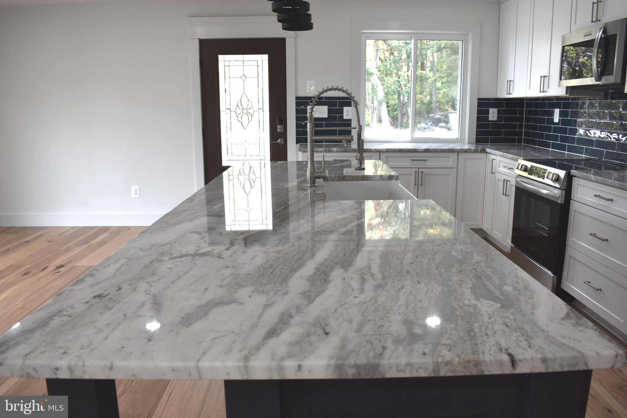 4117 Crow Rock Road Myersville, MD 21773 - Photo 19 of 97 a kitchen with granite countertop a stove a sink and a microwave