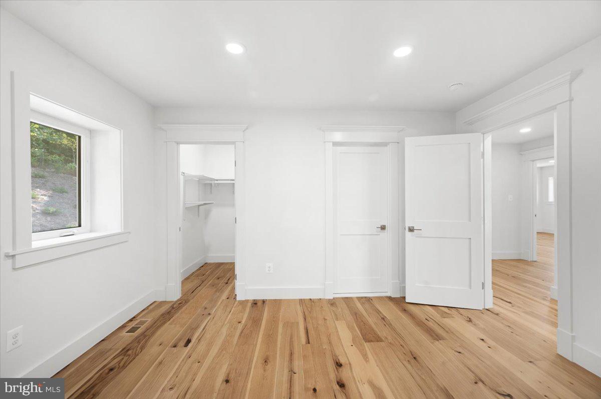 4117 Crow Rock Road Myersville, MD 21773 - Photo 23 of 97 a view of empty room with wooden floor and fan