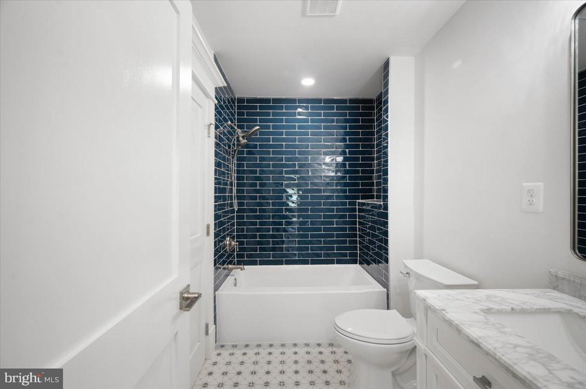 4117 Crow Rock Road Myersville, MD 21773 - Photo 24 of 97 a bathroom with a granite countertop toilet and a shower