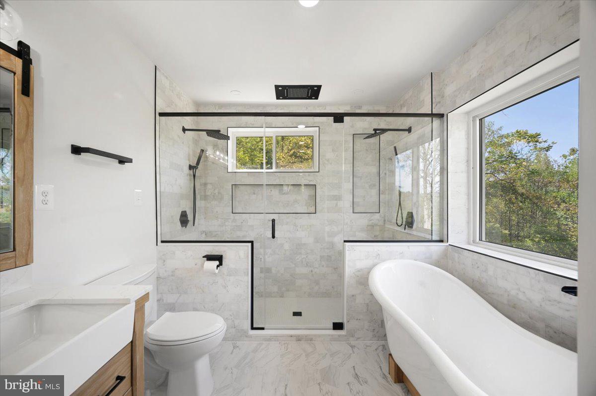 4117 Crow Rock Road Myersville, MD 21773 - Photo 28 of 97 a bathroom with a granite countertop sink toilet and shower