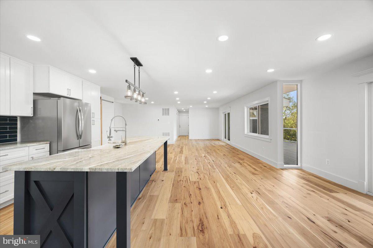 4117 Crow Rock Road Myersville, MD 21773 - Photo 3 of 97 a large kitchen with kitchen island a refrigerator a sink dishwasher a stove and a refrigerator with wooden floor