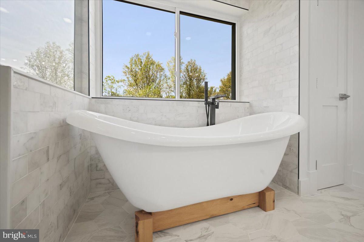 4117 Crow Rock Road Myersville, MD 21773 - Photo 32 of 97 a white bath tub sitting in a bathroom