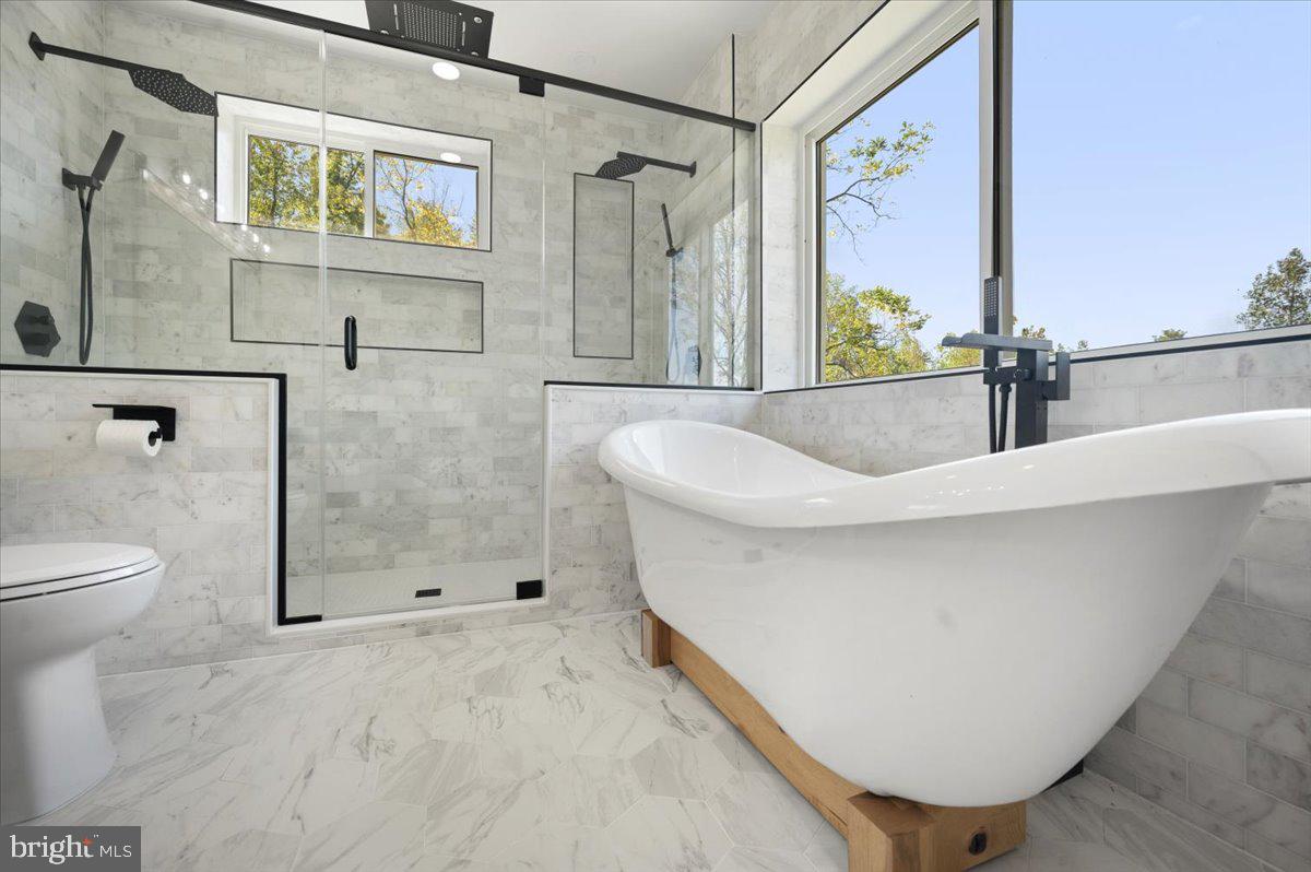 4117 Crow Rock Road Myersville, MD 21773 - Photo 33 of 97 a white bath tub sitting next to a toilet