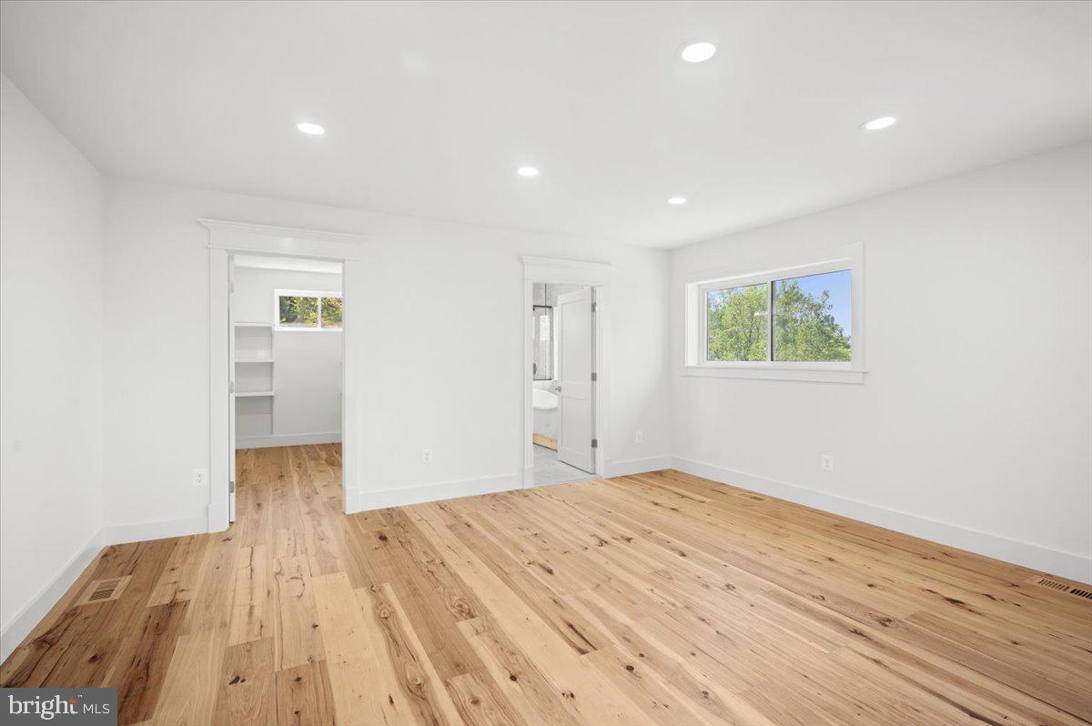 4117 Crow Rock Road Myersville, MD 21773 - Photo 39 of 97 a view of empty room with wooden floor and fan