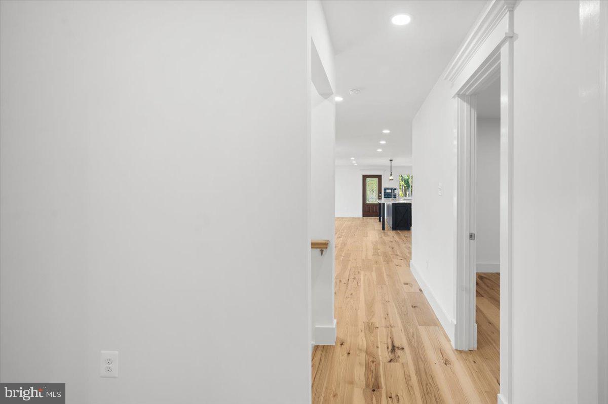 4117 Crow Rock Road Myersville, MD 21773 - Photo 43 of 97 a view of a hallway with wooden floor and staircase