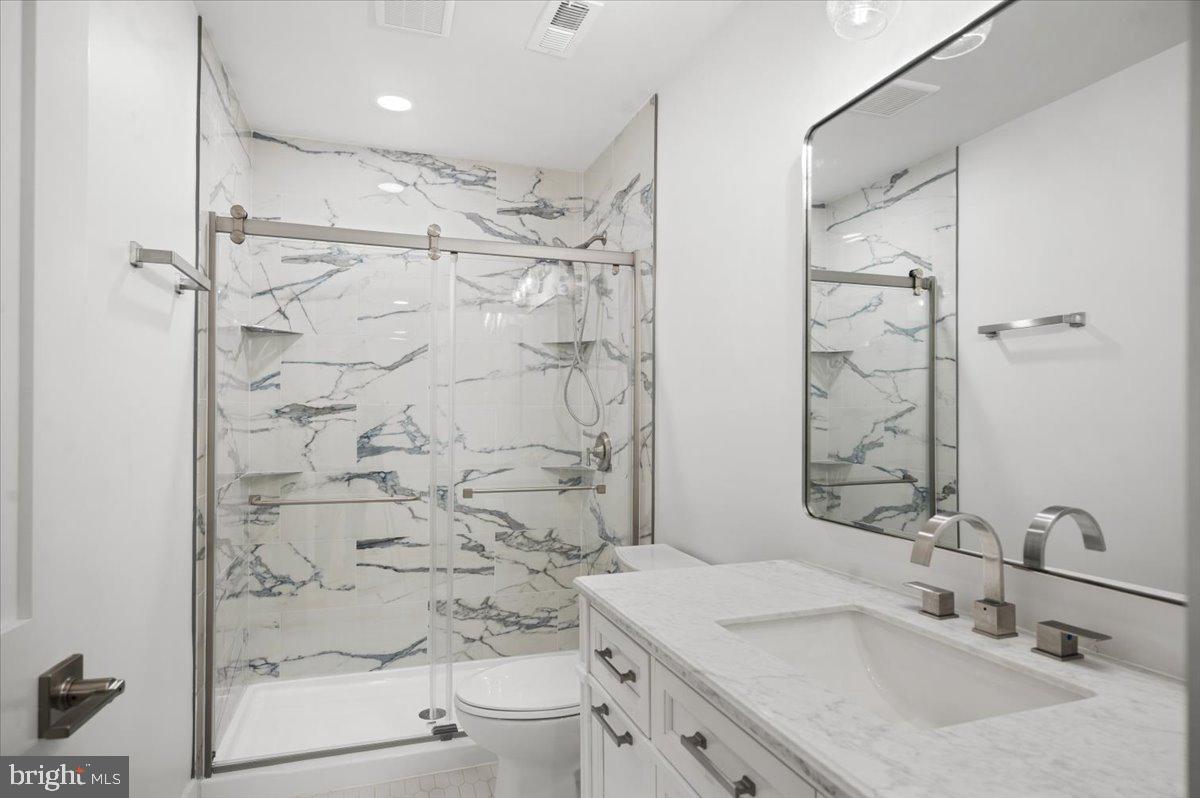 4117 Crow Rock Road Myersville, MD 21773 - Photo 56 of 97 a bathroom with a sink toilet a shower and a mirror