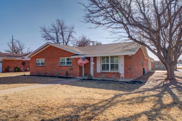 a front view of a house with a yard covered in snow
