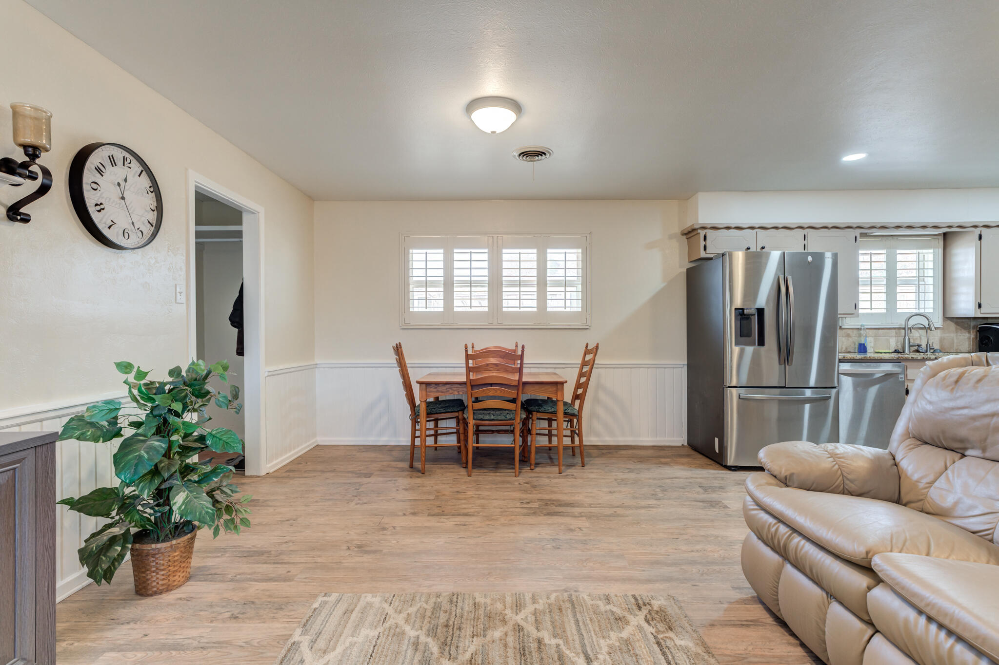 2141 71st Street Lubbock, TX 79412 - Photo 16 of 36 a living room with furniture a clock and a window