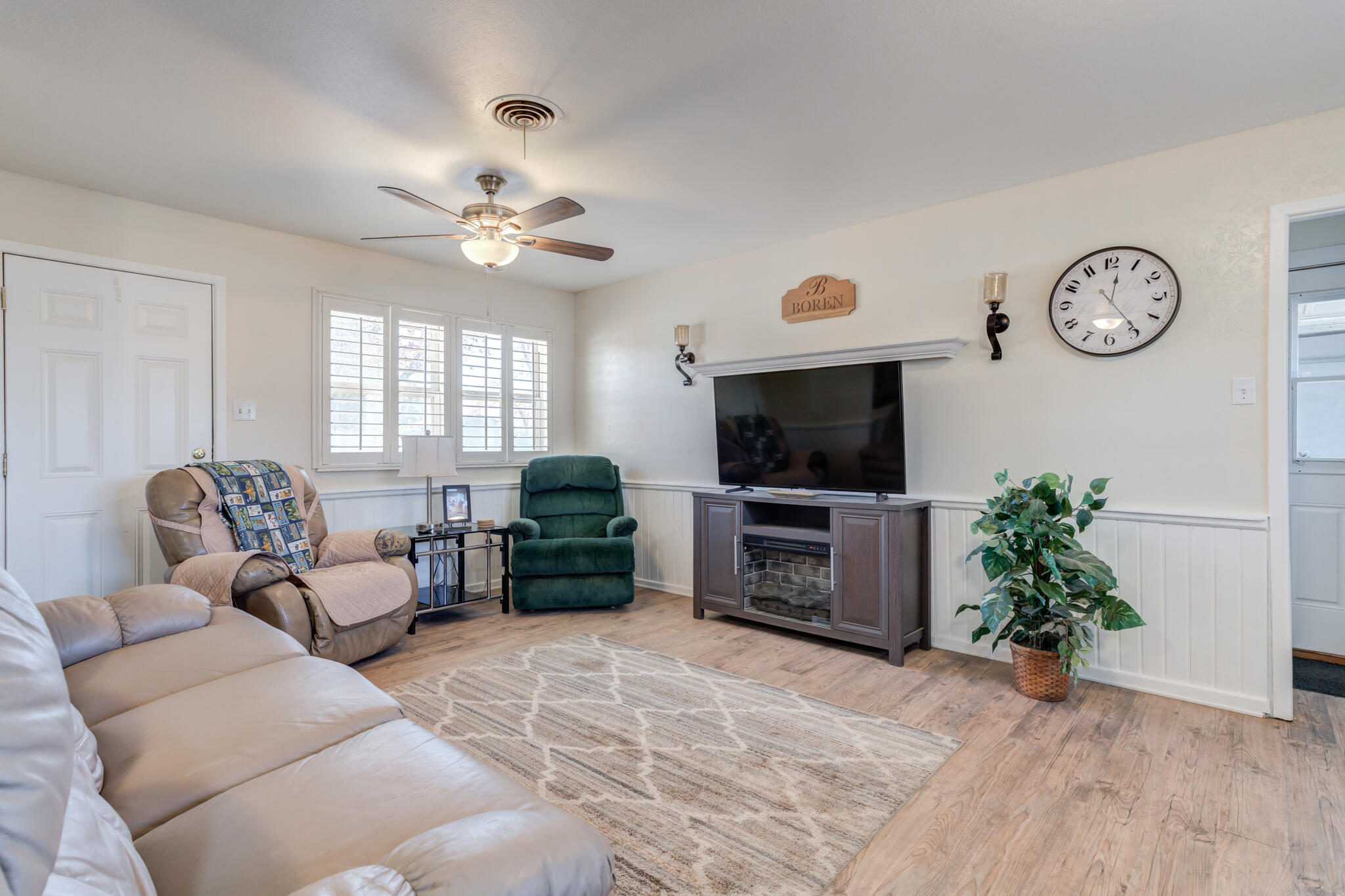 2141 71st Street Lubbock, TX 79412 - Photo 18 of 36 a living room with furniture a flat screen tv and a window