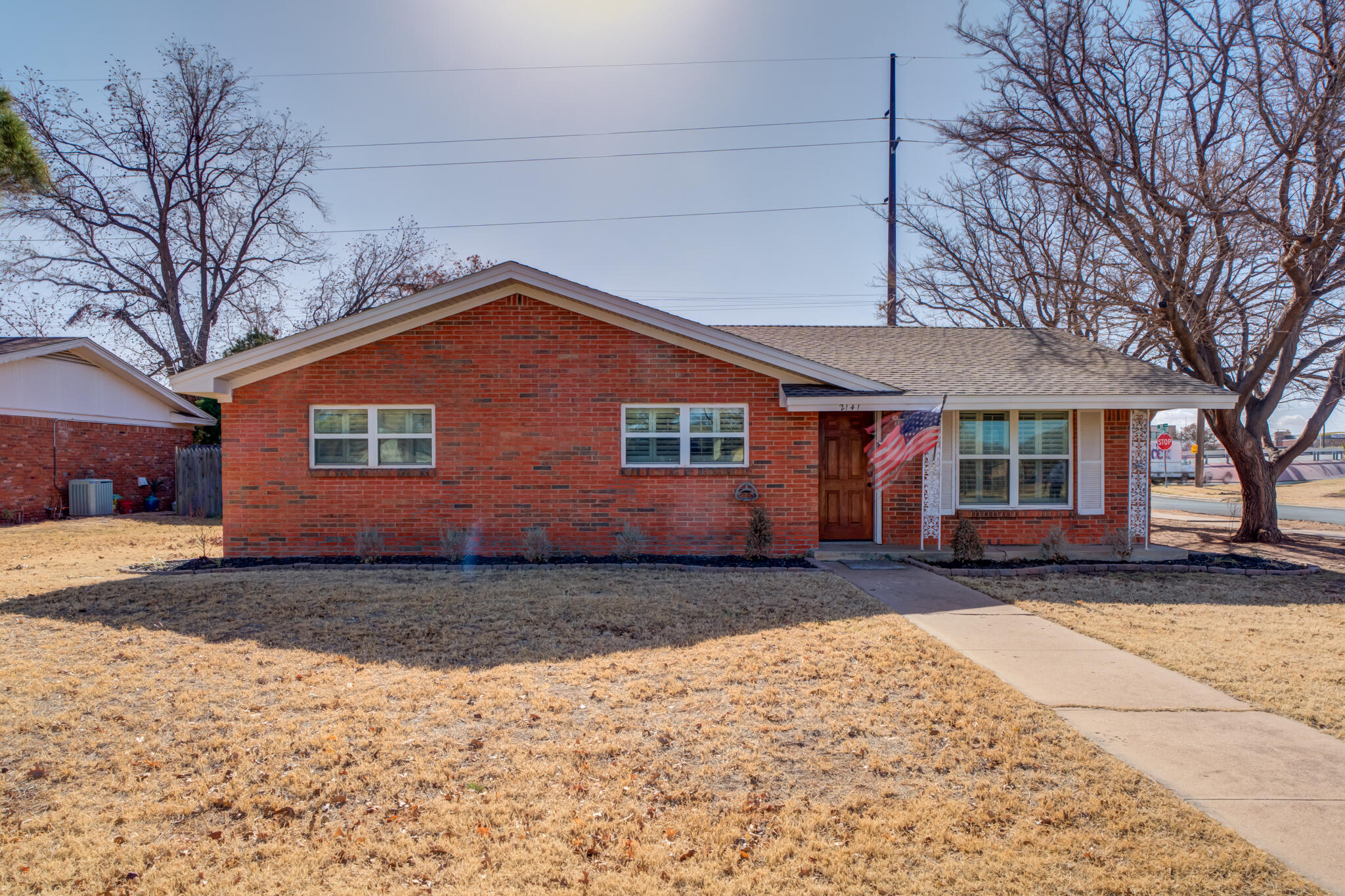 2141 71st Street Lubbock, TX 79412 - Photo 2 of 36 a front view of a house with a yard