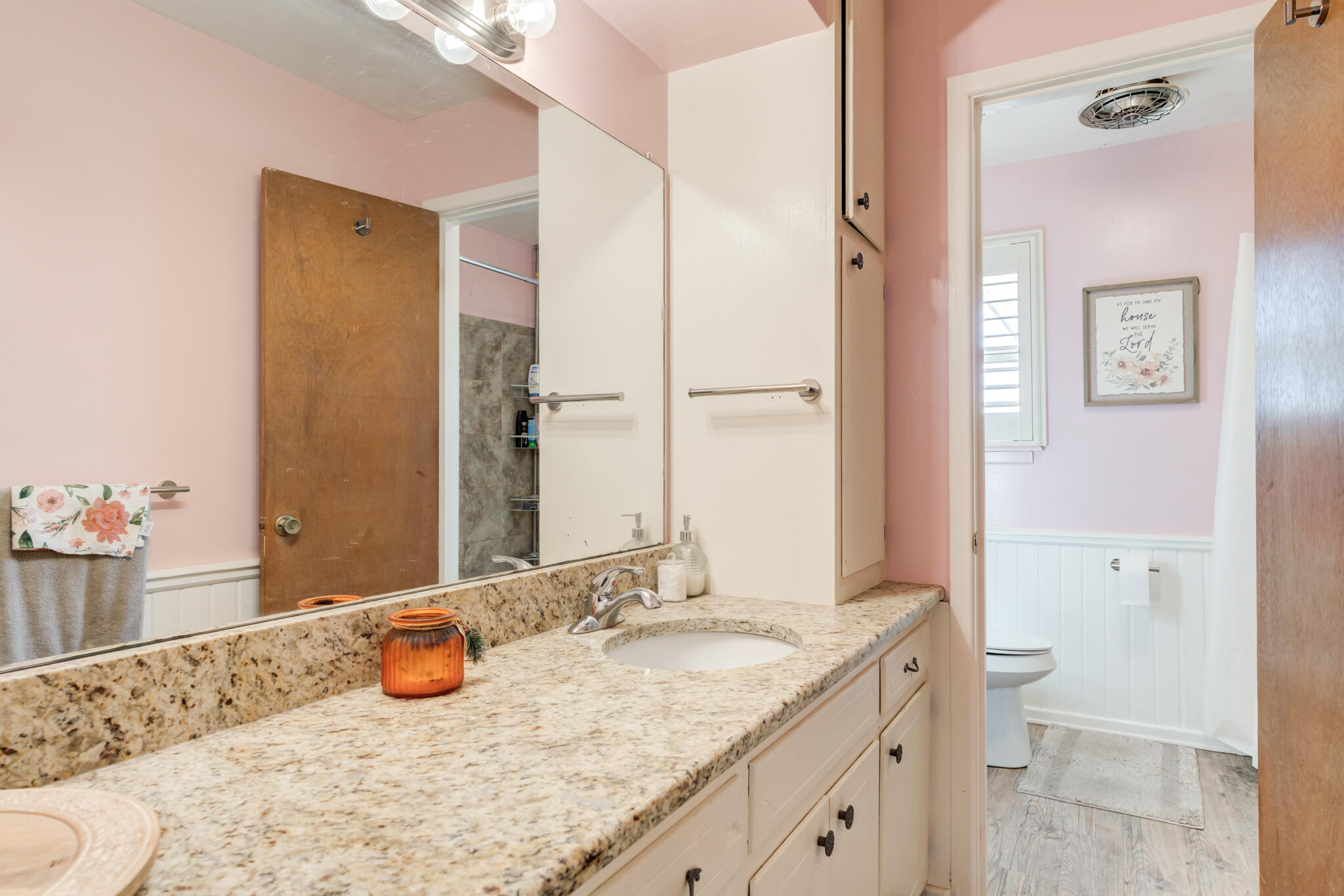 2141 71st Street Lubbock, TX 79412 - Photo 26 of 36 a bathroom with a granite countertop sink and a mirror