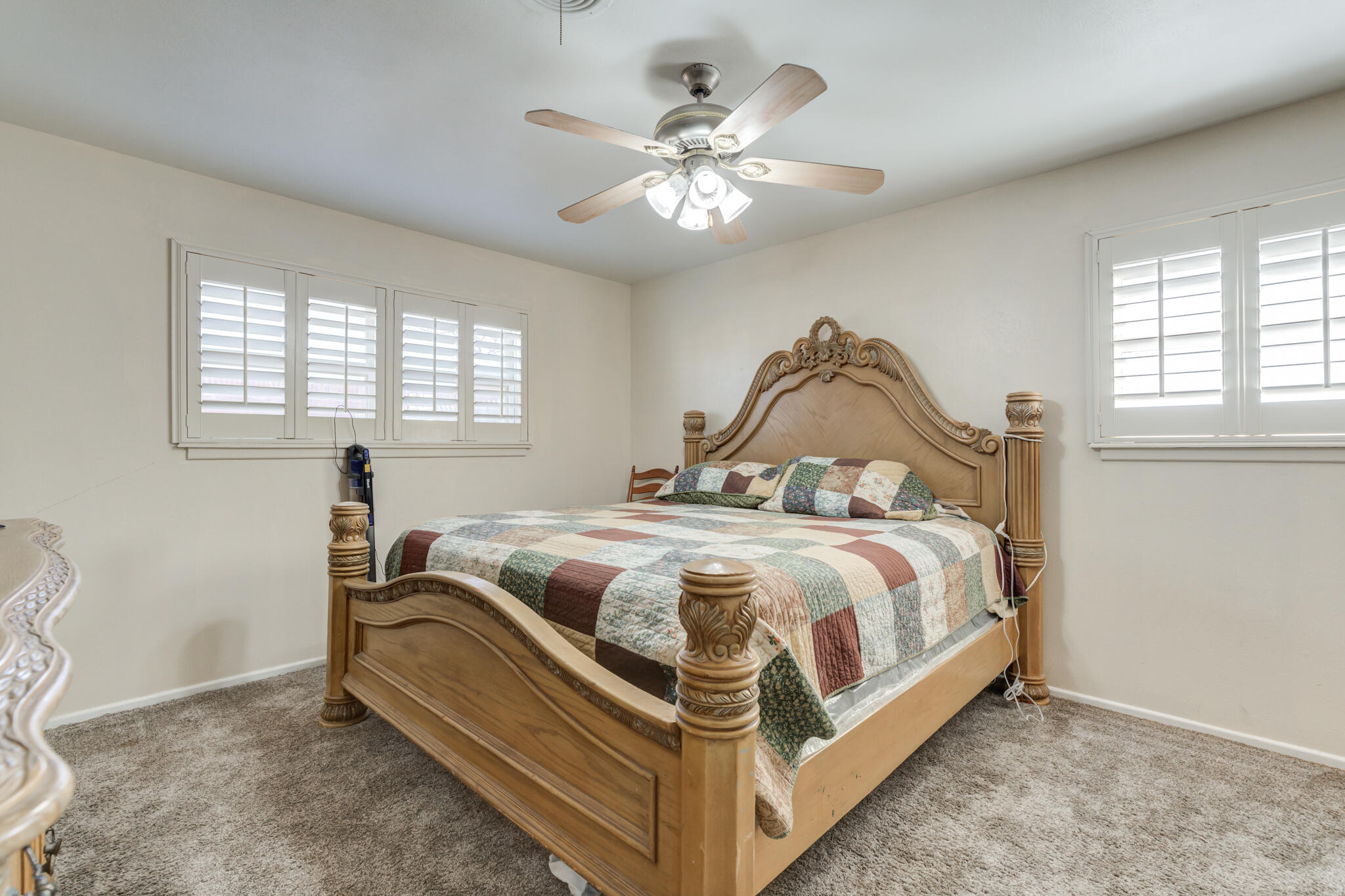 2141 71st Street Lubbock, TX 79412 - Photo 28 of 36 a bedroom with a bed and a chandelier