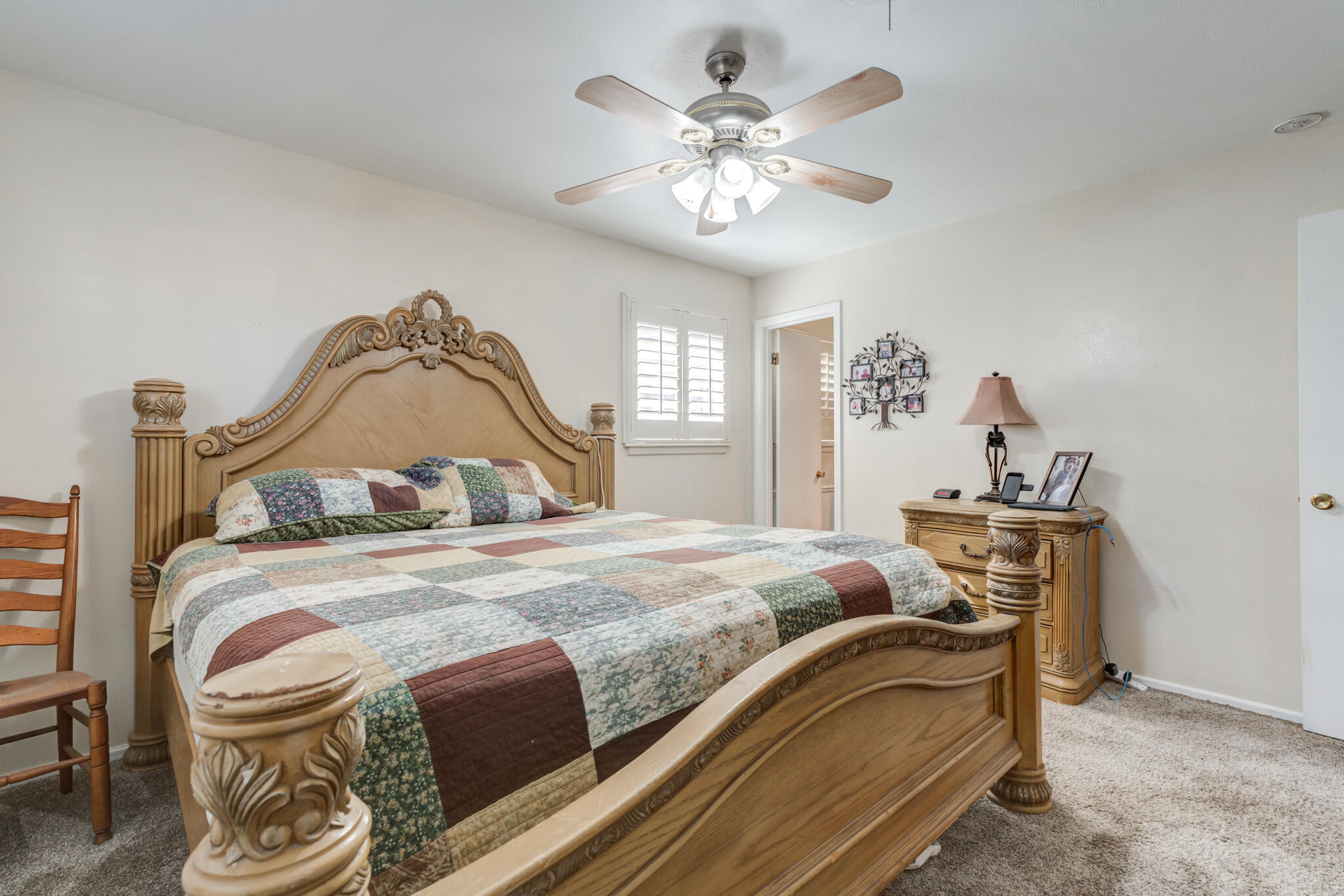 2141 71st Street Lubbock, TX 79412 - Photo 29 of 36 a bedroom with a bed and a chandelier