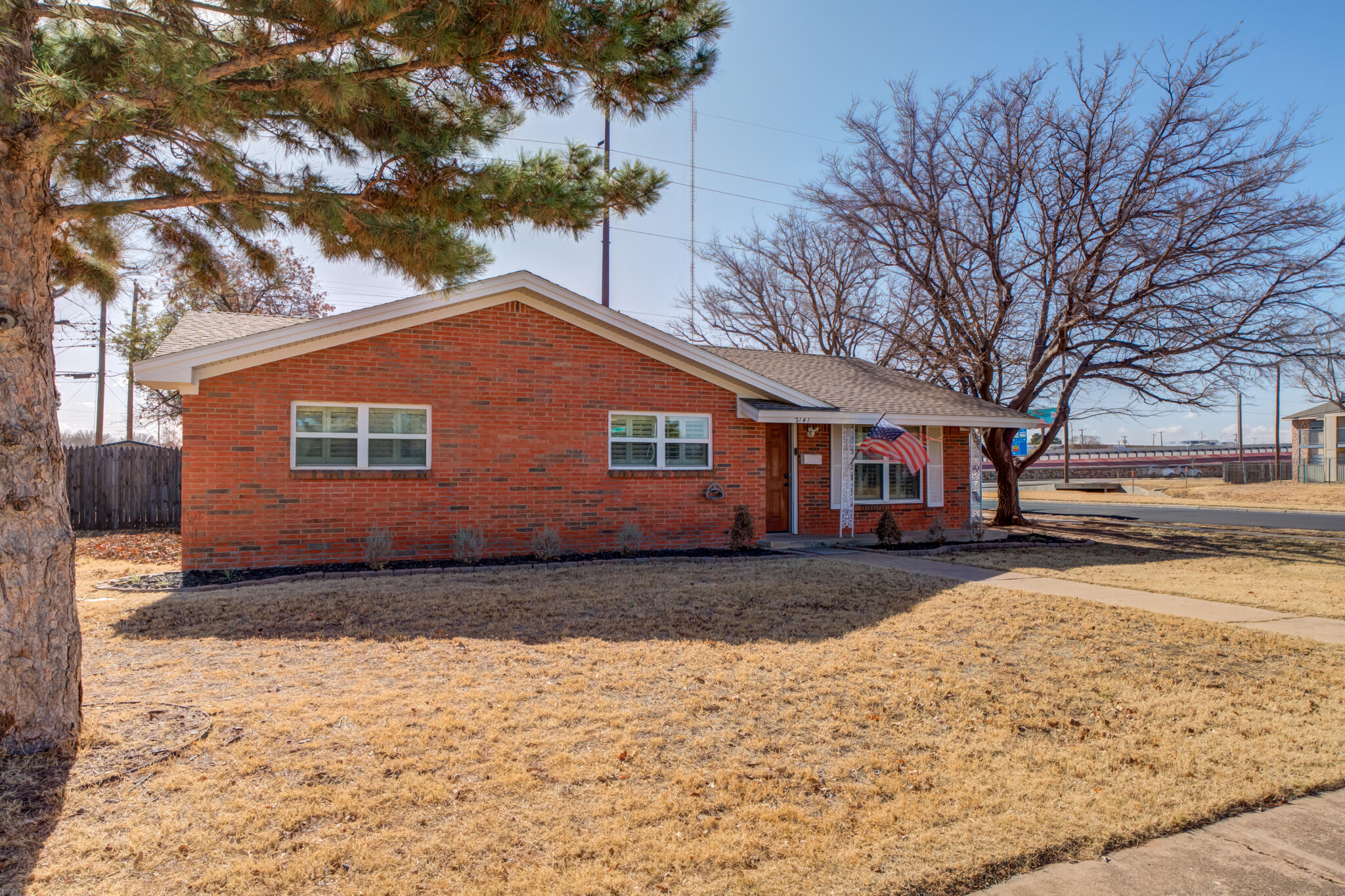 2141 71st Street Lubbock, TX 79412 - Photo 3 of 36 a front view of a house with a yard covered in snow