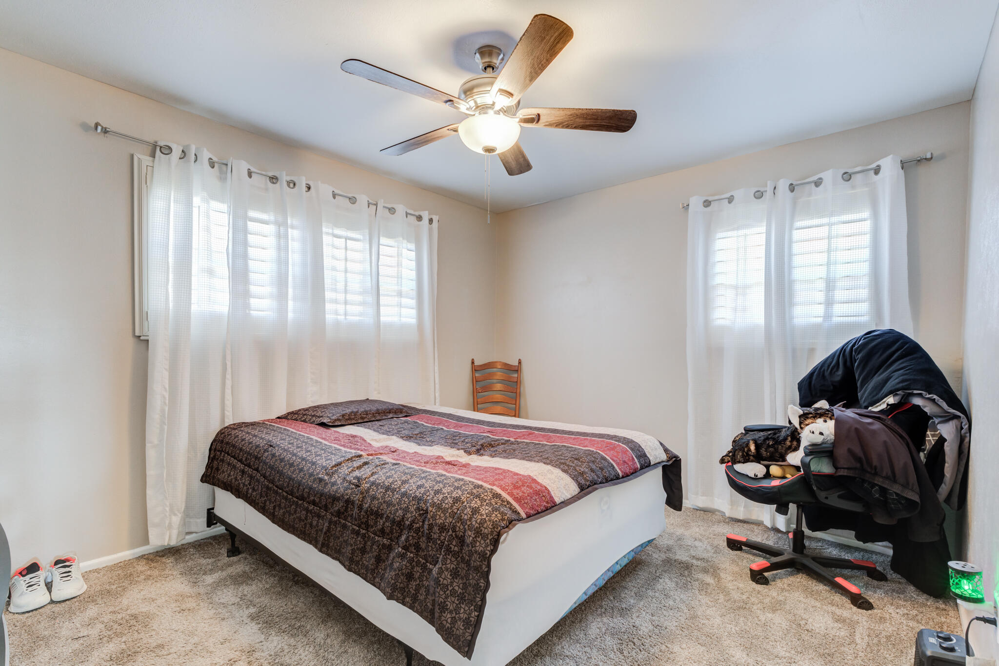 2141 71st Street Lubbock, TX 79412 - Photo 31 of 36 a bedroom with a bed and a chandelier