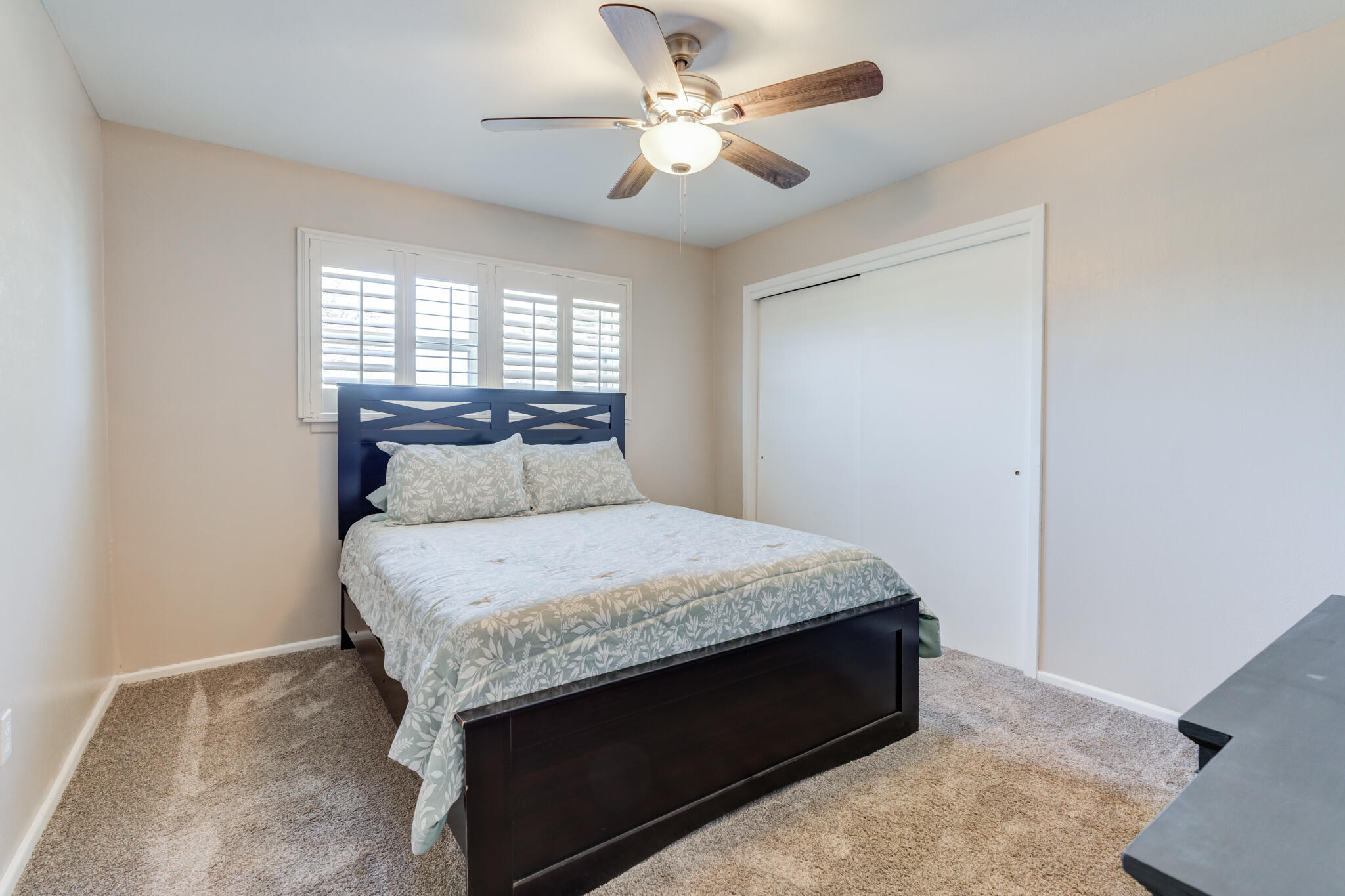2141 71st Street Lubbock, TX 79412 - Photo 32 of 36 a bed sitting in a bedroom next to a window