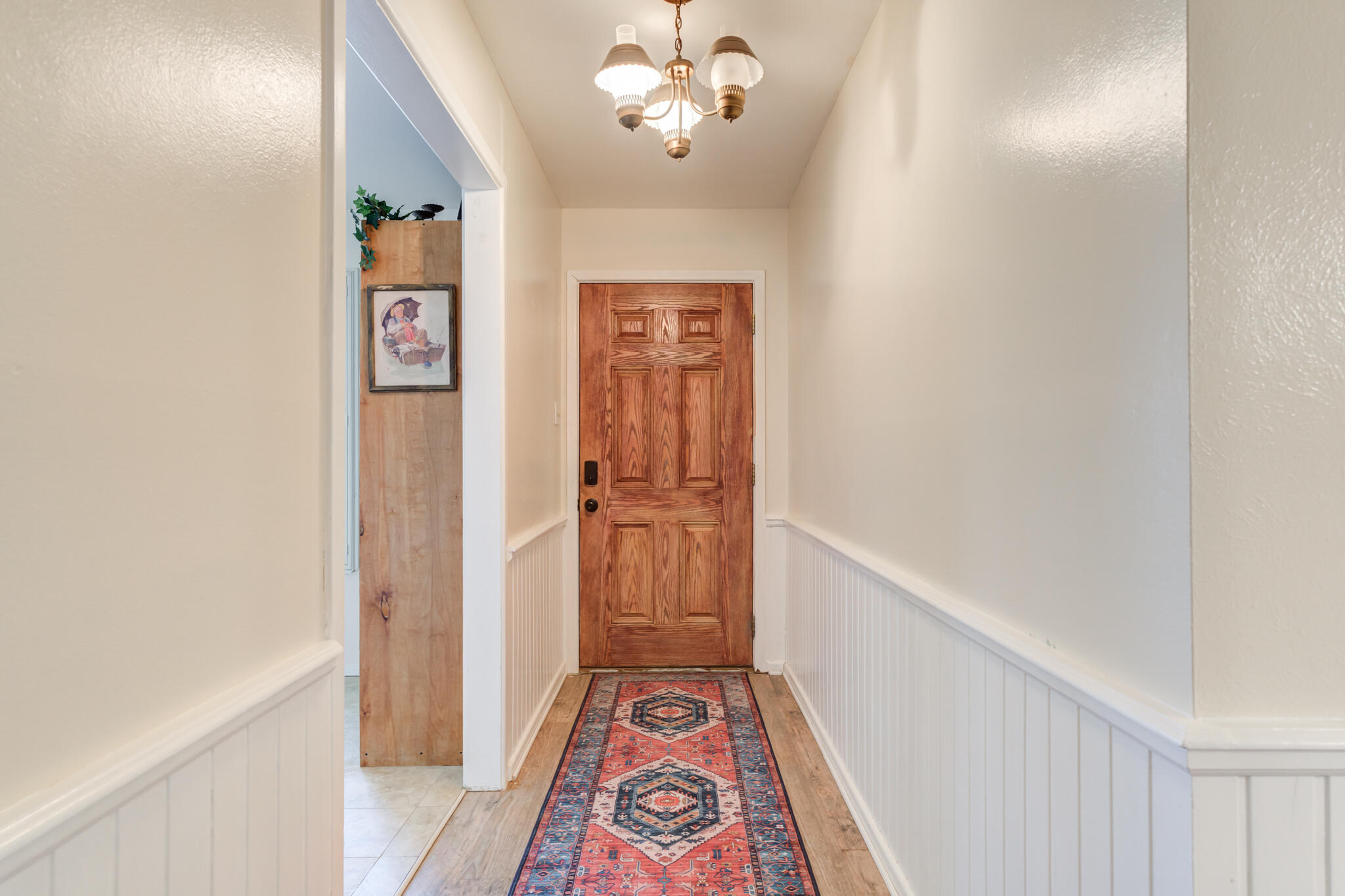 2141 71st Street Lubbock, TX 79412 - Photo 5 of 36 a view of a hallway with wooden floor