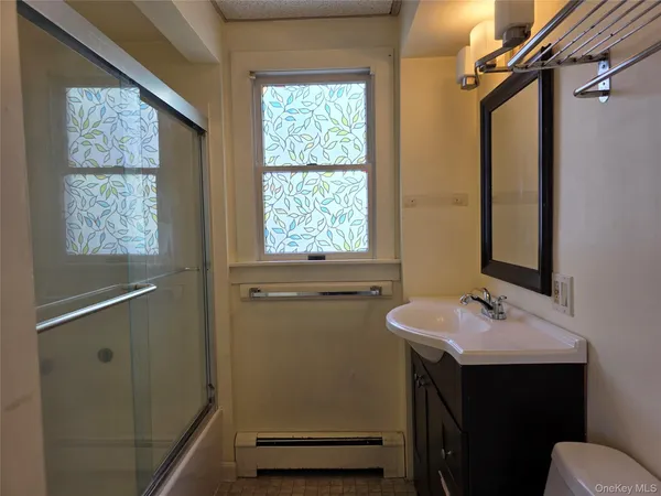 a bathroom with a sink vanity and a mirror