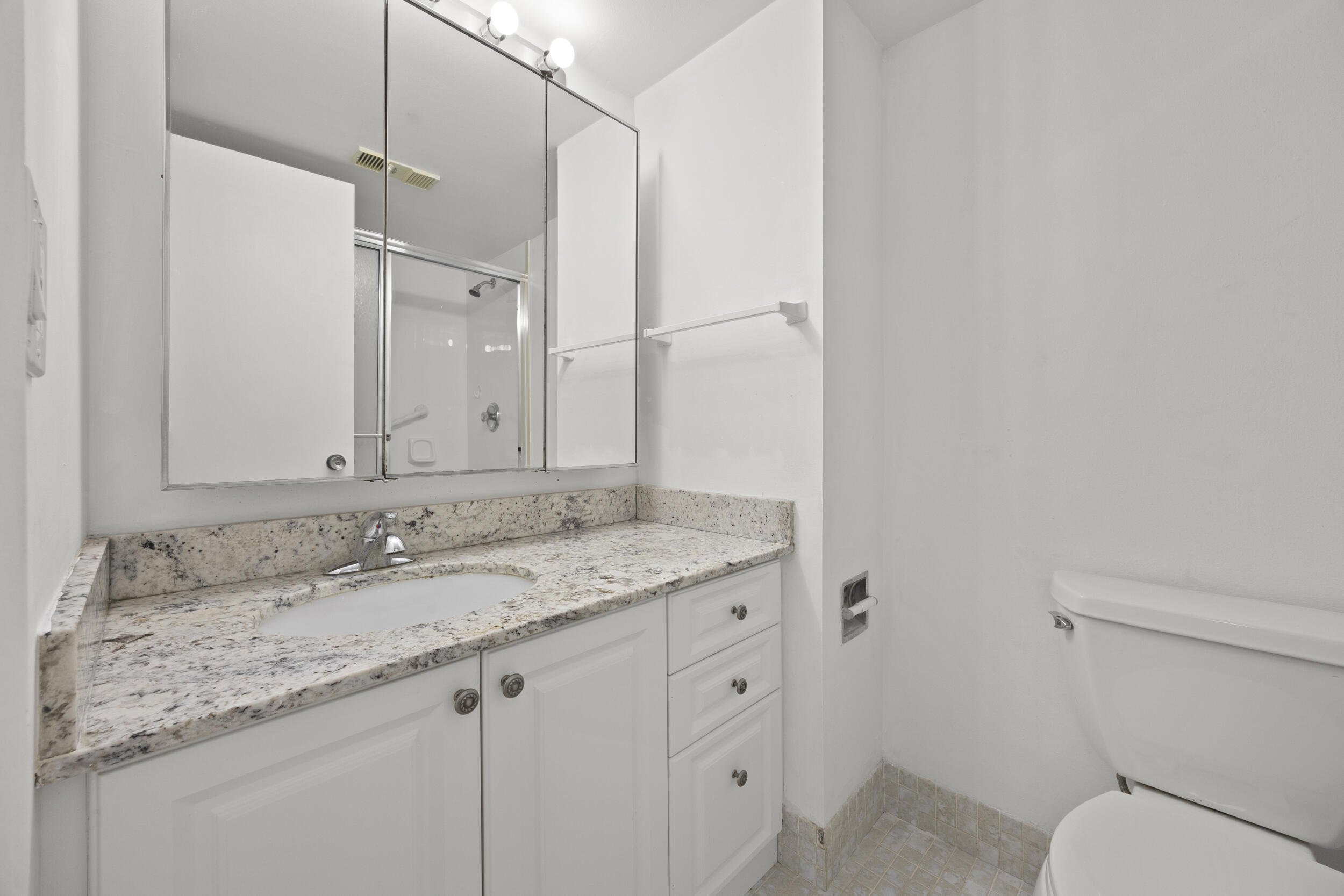 1401 South Federal Highway, Unit 220 Boca Raton, FL 33432 - Photo 26 of 27 a bathroom with a granite countertop sink a mirror and a toilet
