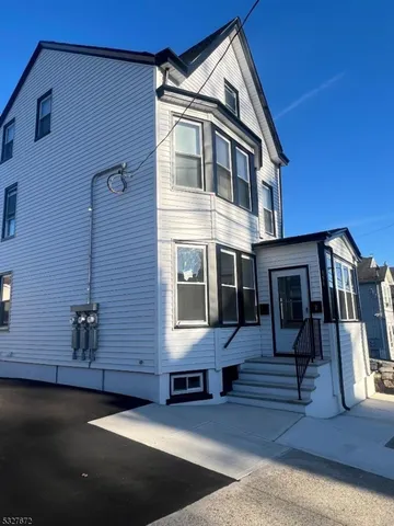 a front view of a house with many windows