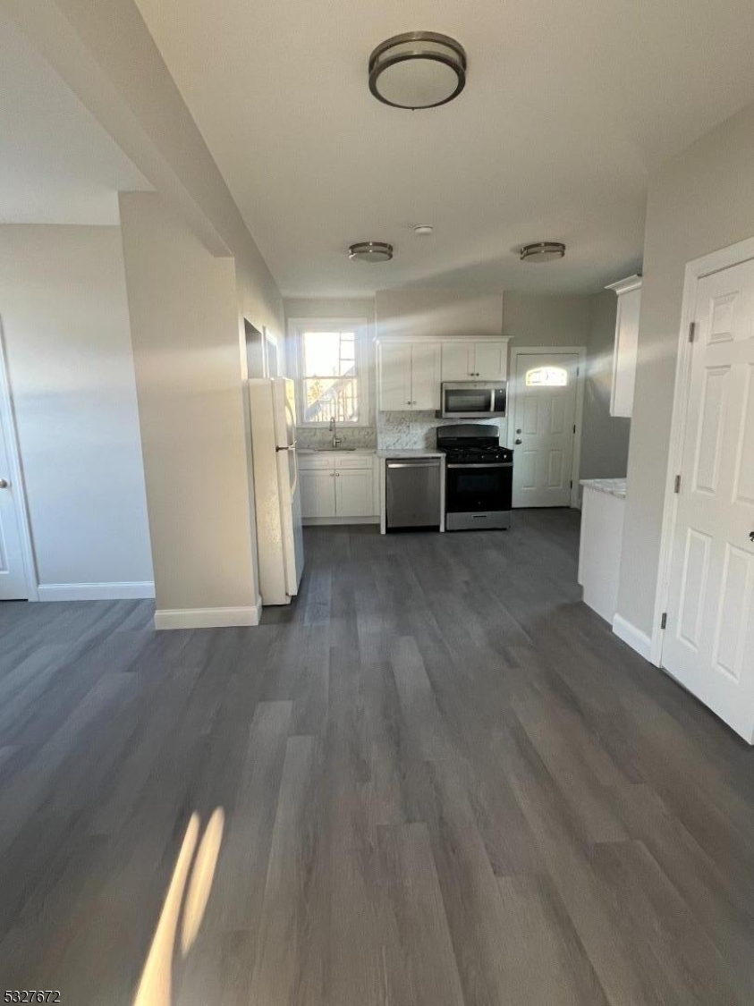 149 Atlantic Street Paterson, NJ 07503 - Photo 2 of 11 a view of a electric appliances in kitchen and empty room