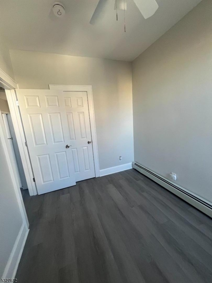 149 Atlantic Street Paterson, NJ 07503 - Photo 6 of 11 an empty room with wooden floor