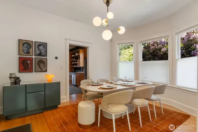 a view of a dining room with furniture and chandelier