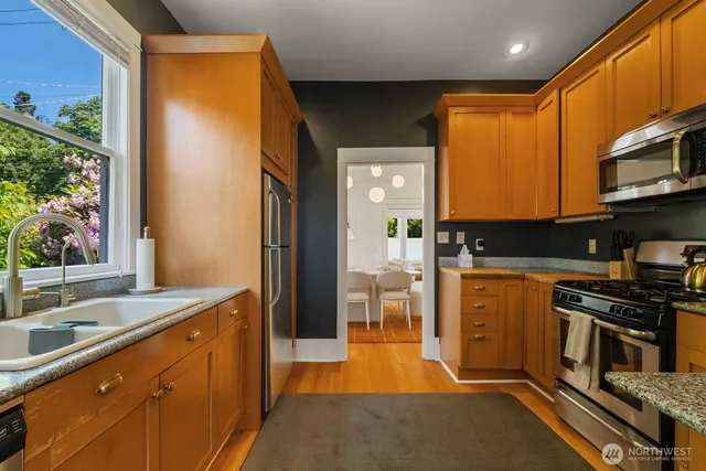 a kitchen with stainless steel appliances a stove sink and cabinets