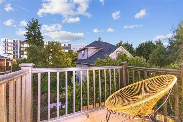a view of a chair and tables in the balcony