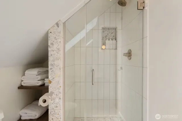 a bathroom with a toilet and shower