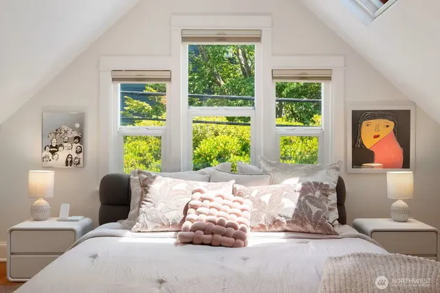 a bedroom with bed and a large window