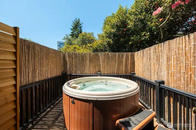 a view of a jacuzzi with wooden fence