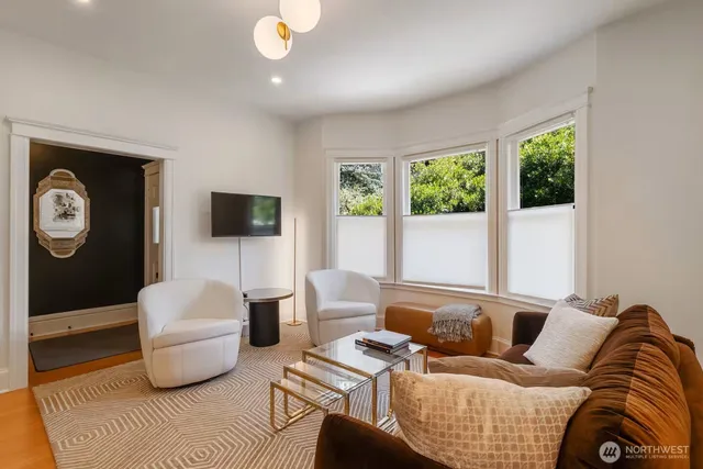 a living room with furniture and a flat screen tv