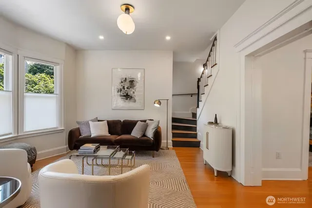 a living room with furniture and a chandelier