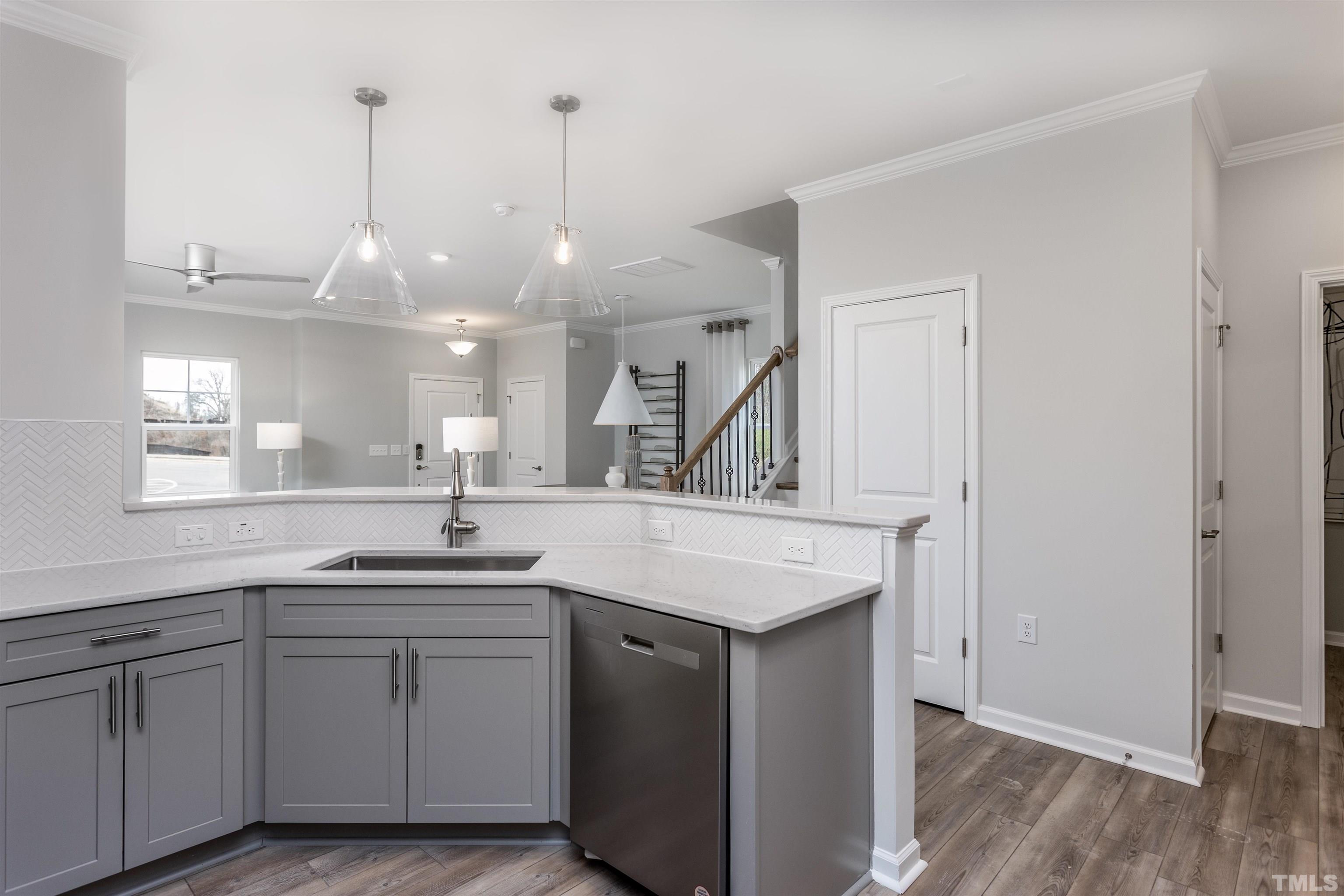 4906 Megara Run, Unit ROYAL Raleigh, NC 27603 - Photo 12 of 23 a kitchen with a sink dishwasher and cabinets with wooden floor