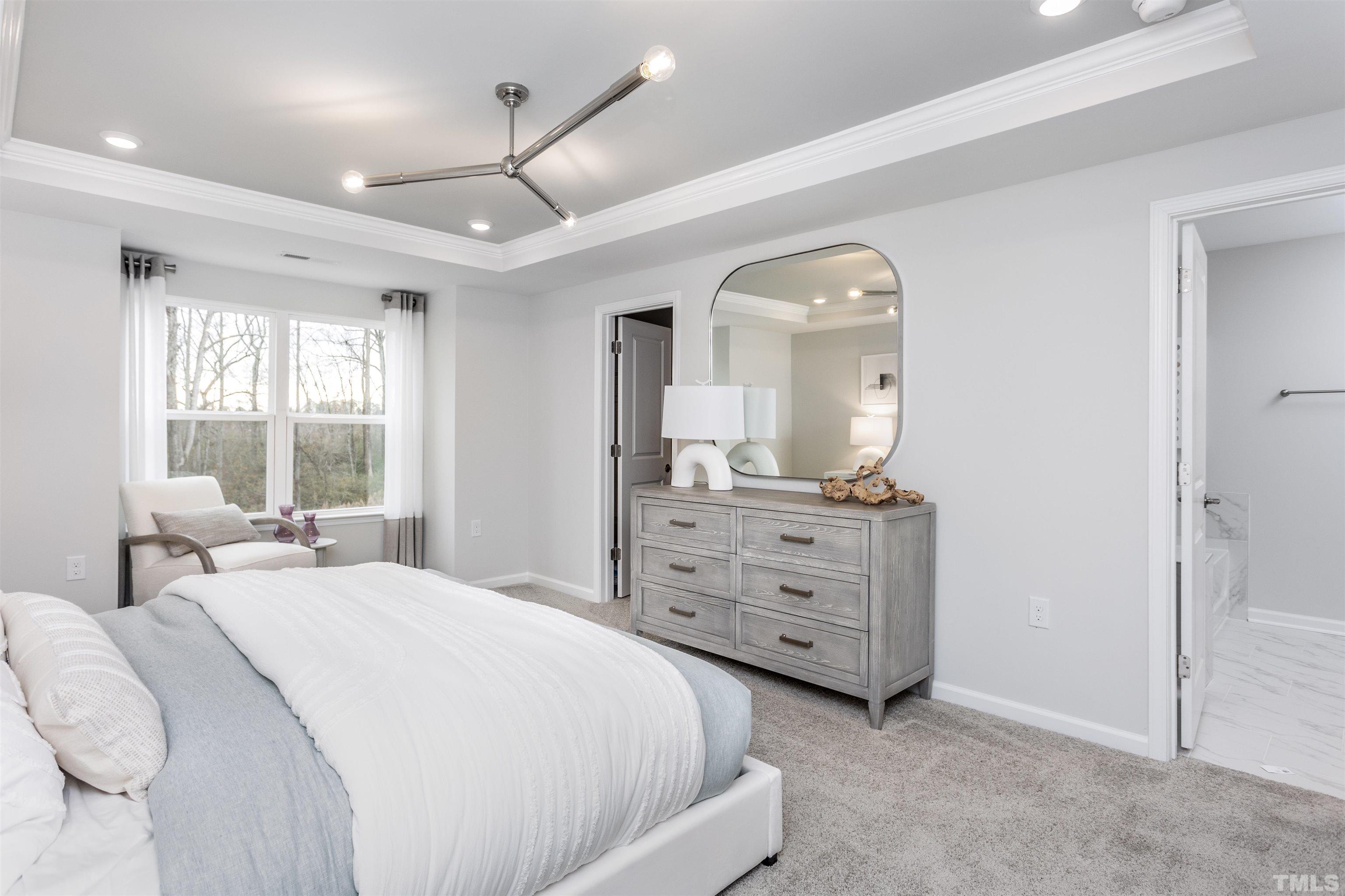 4906 Megara Run, Unit ROYAL Raleigh, NC 27603 - Photo 16 of 23 a spacious bedroom with a bed a window and dresser