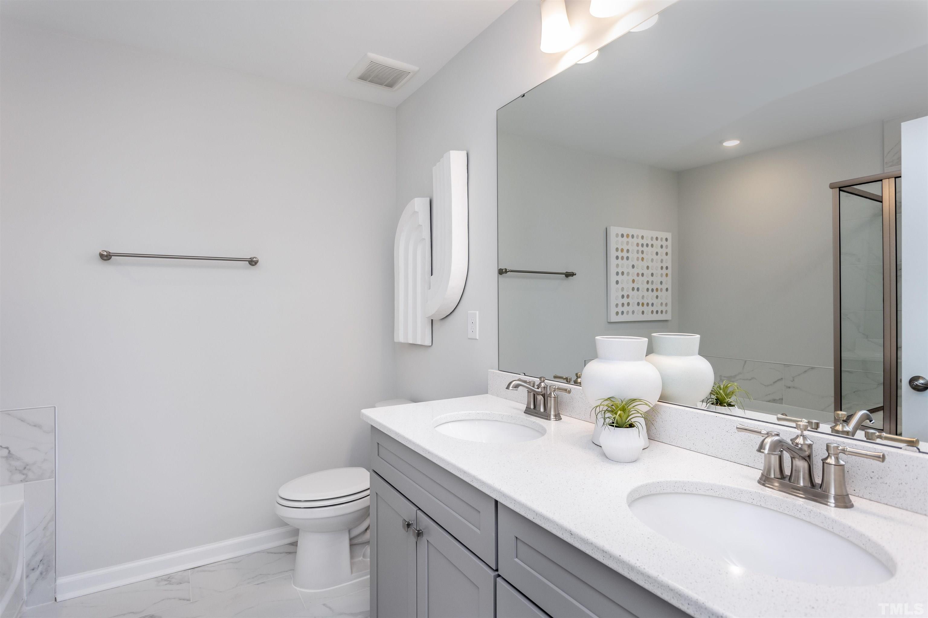 4906 Megara Run, Unit ROYAL Raleigh, NC 27603 - Photo 17 of 23 a bathroom with a sink toilet and mirror
